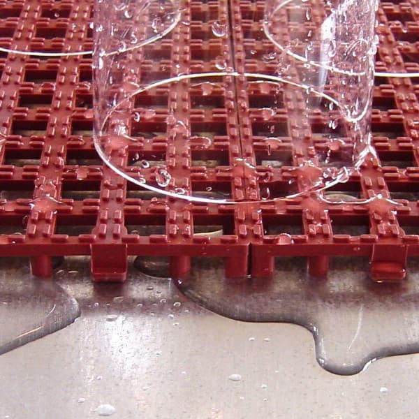 Raised Grip-Loc Tiles, Brick Red — EVA drainage tile surface with clear cups