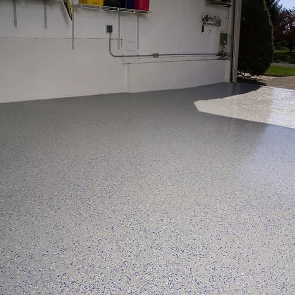 Epoxy garage coating in garage with a red car parked in the driveway.