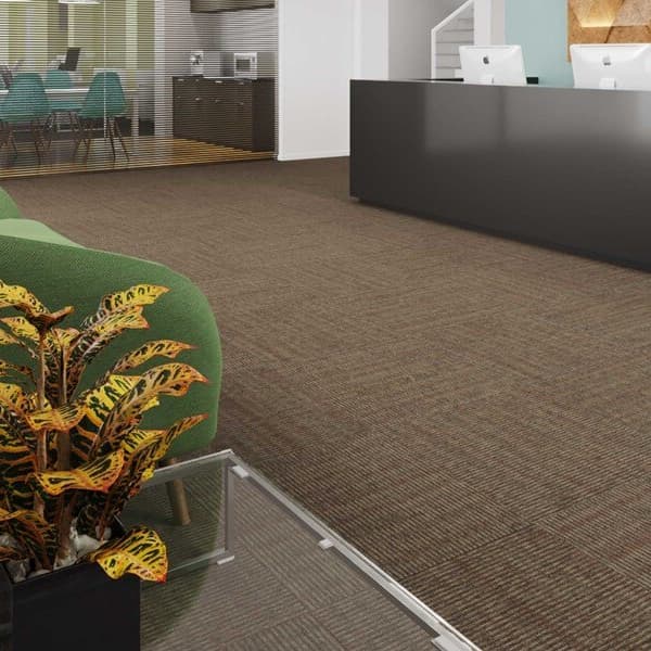 Pentz Sidewinder Carpet Tiles in Desert Spring — office reception area with green sofa, plant, and dark reception desk