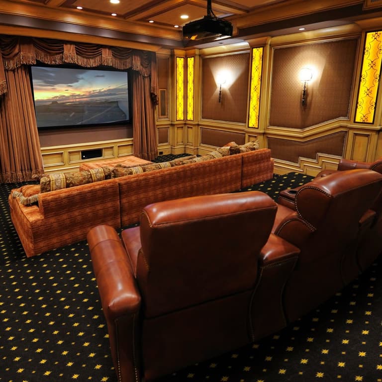 Home theater with Joy Carpets Walk of Fame carpet in black with gold star pattern under leather recliners and sectional sofa