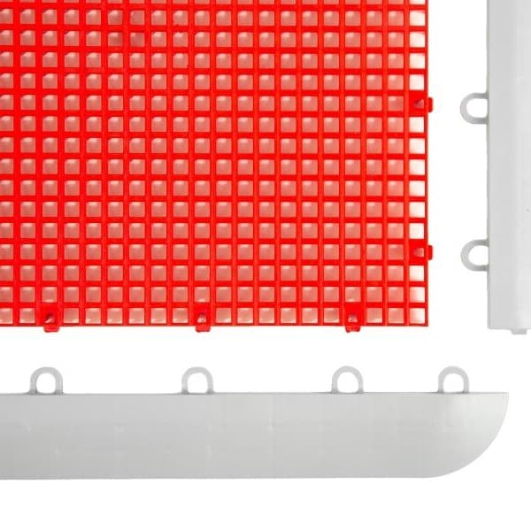 Red polypropylene court tile with gray edge pieces, close-up view