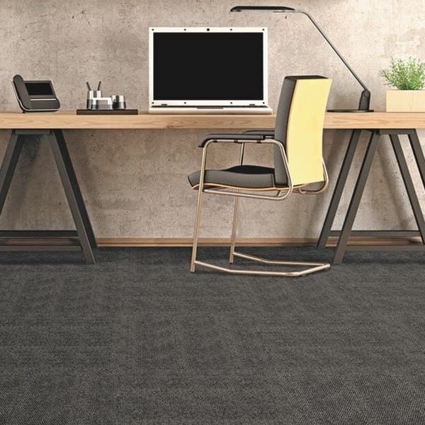 Home office with Foss Hobnail Carpet Tile — dark gray textured carpet under a wooden desk and chair