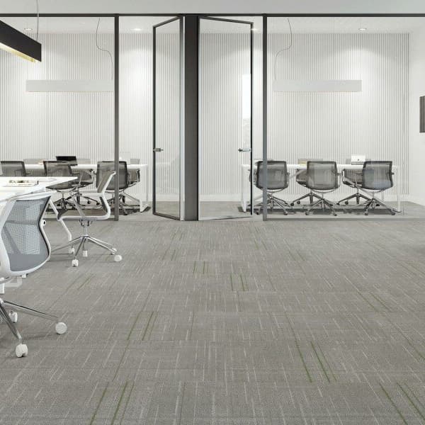 Modern office space with Mannington Dispatch Carpet Tiles in Dialtone — gray carpet with subtle green linear pattern under