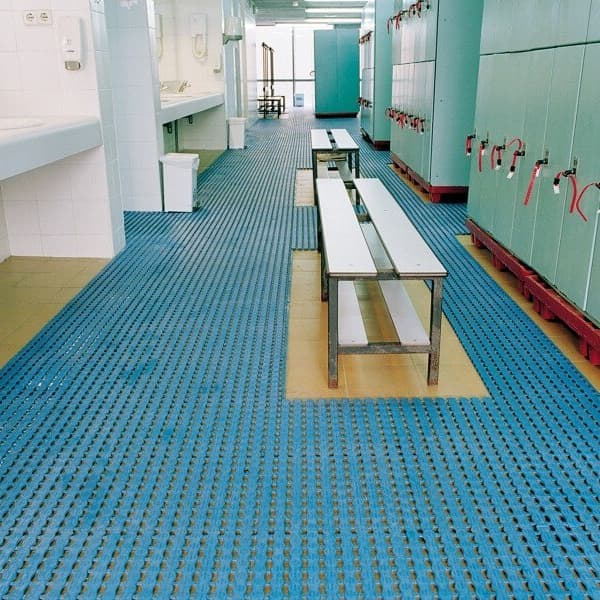 Ocean Blue Plastex Herontile anti-slip wet area tiles installed in a locker room with benches and sinks